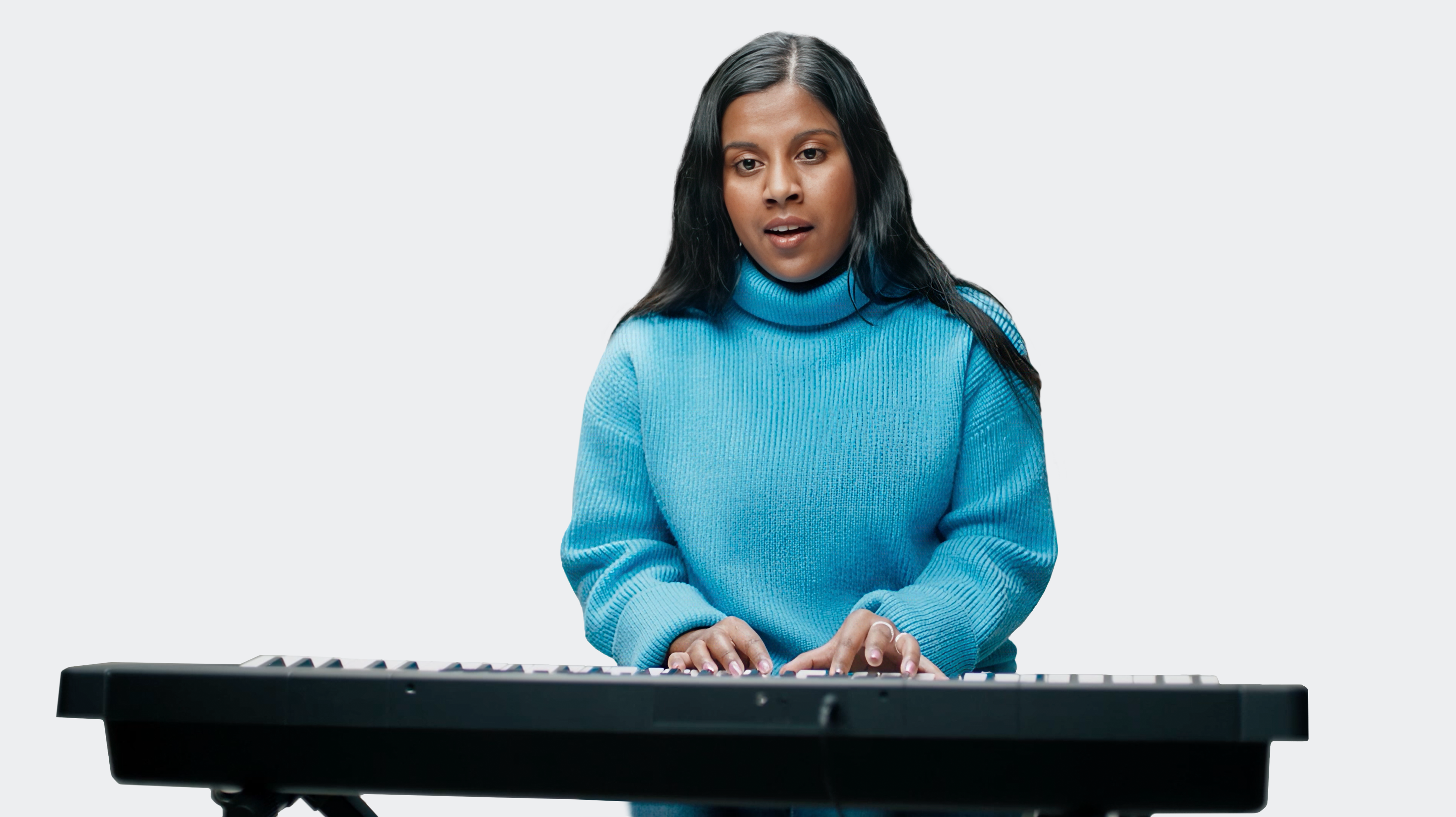 Ramya, a woman living with an inherited retinal disease (IRD), playing the keyboard