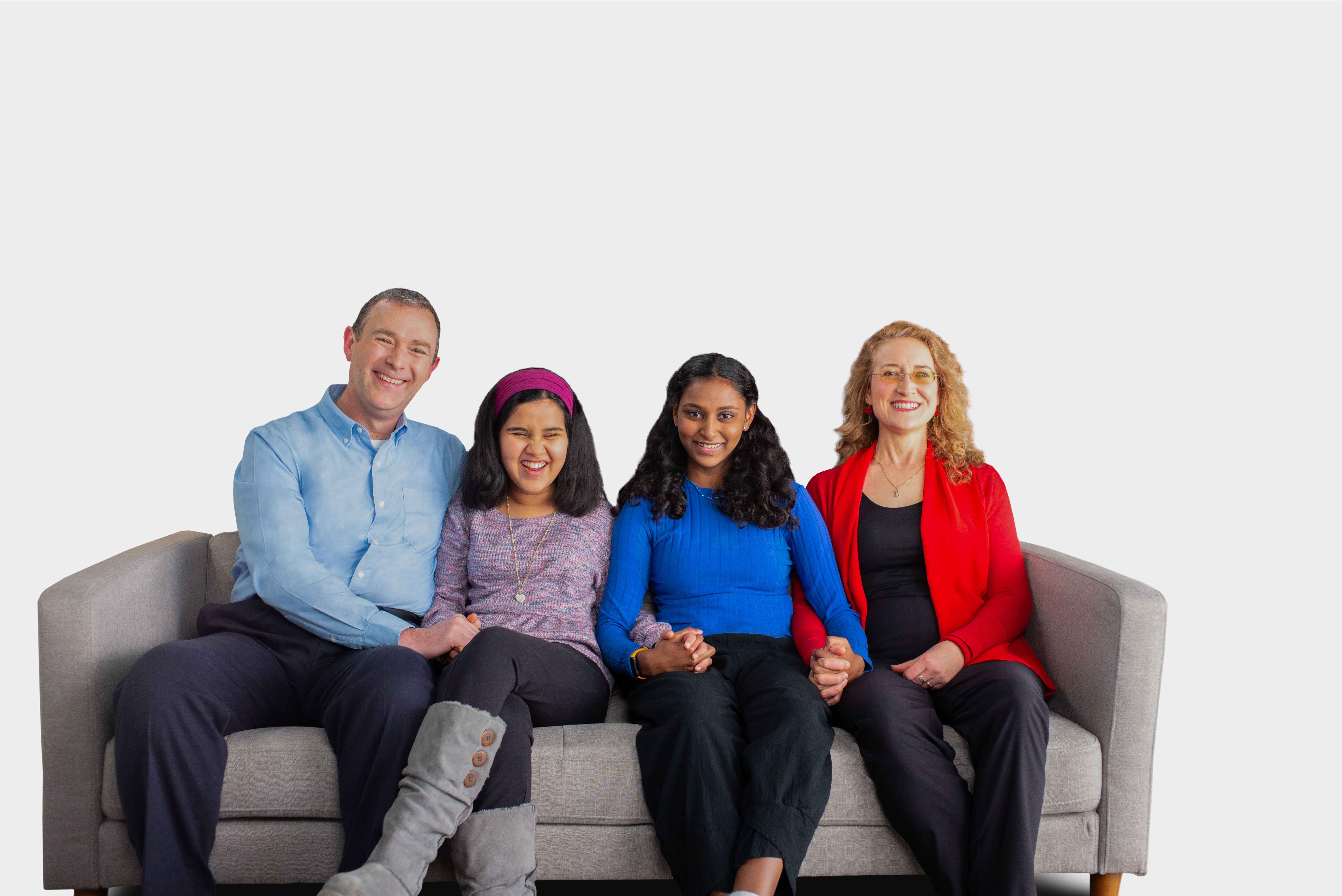 Lisa, woman with an inherited retinal disease (IRD), sitting on a couch with her family