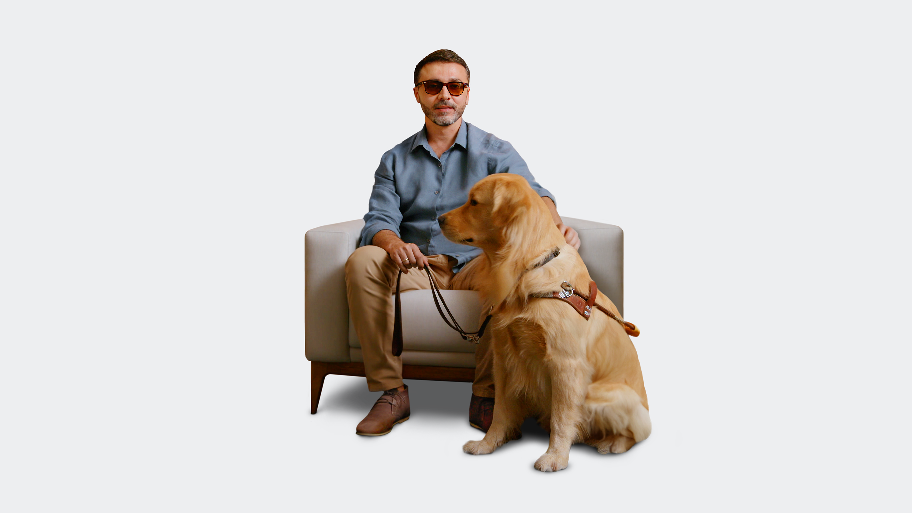 Vision-impaired man with an inherited retinal disease (IRD) sitting with guide dog