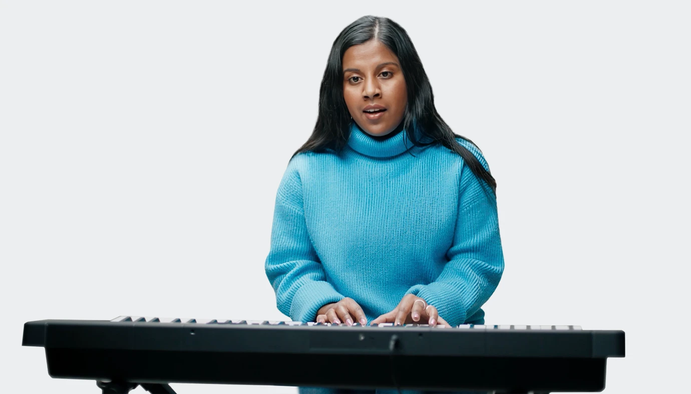 Ramya, a woman living with an inherited retinal disease (IRD), playing the keyboard