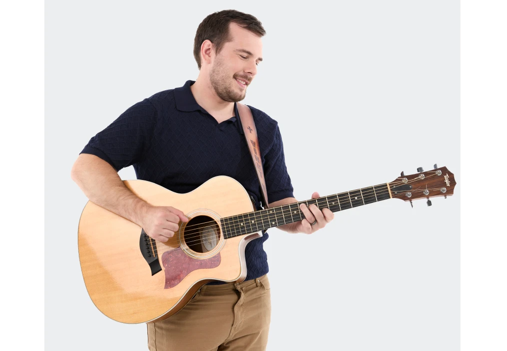 Vinny, a man living with an inherited retinal disease (IRD), playing the guitar