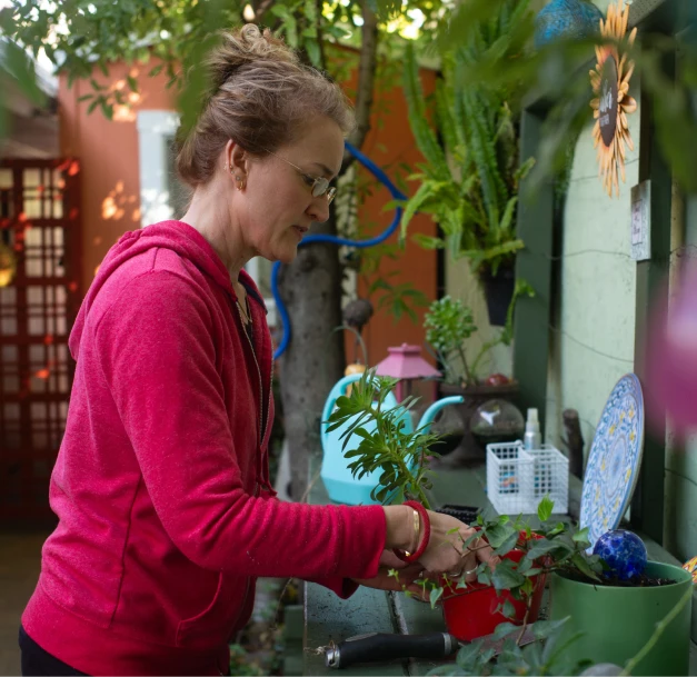 Lisa, a woman living with an inherited retinal disease (IRD), gardening