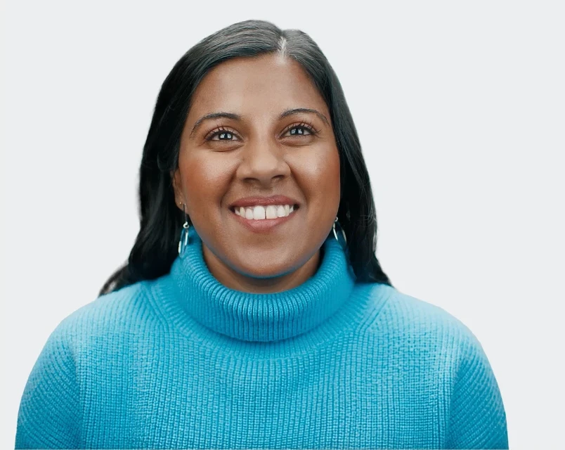 Ramya, a woman living with an inherited retinal disease (IRD), smiling at the camera